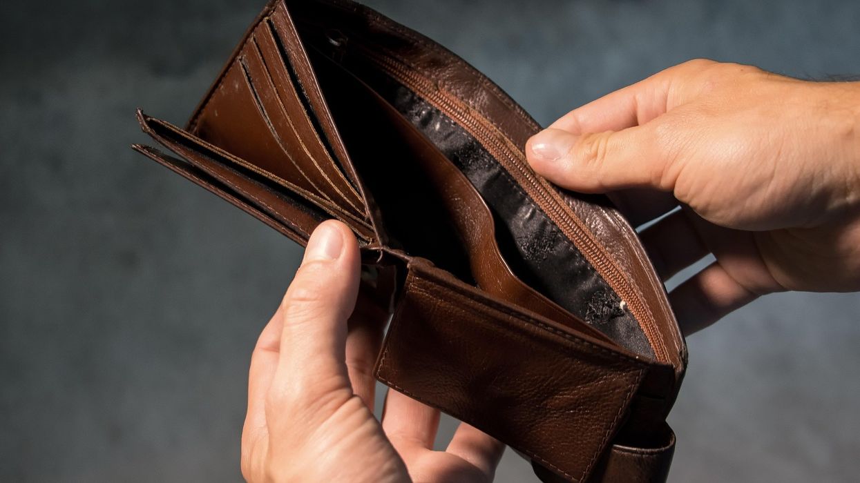 Person looking in empty wallet