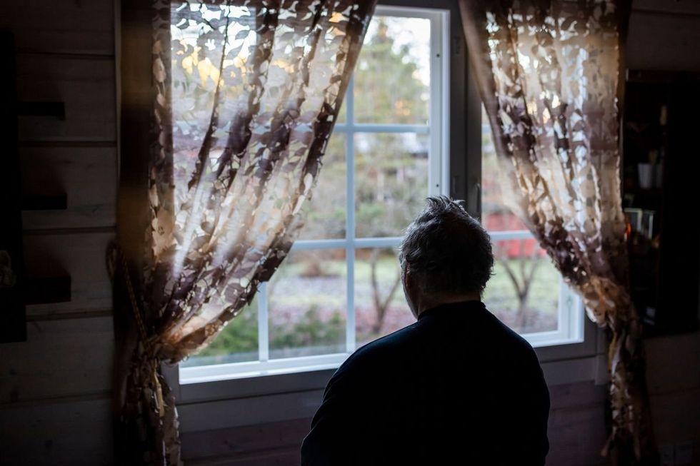 PESSOA OLHANDO PELA JANELA