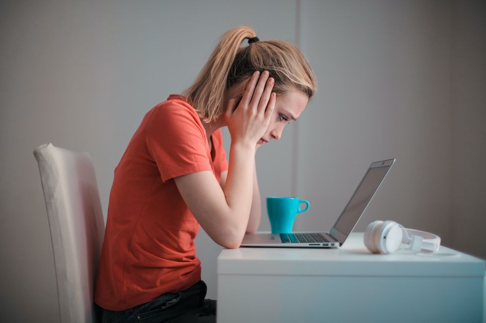 Person looking worried at laptop