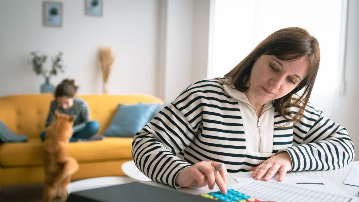 Person looks at budget with calculator
