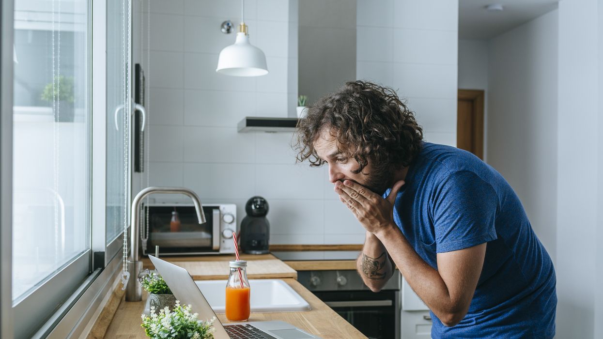 Person looks at laptop in shock