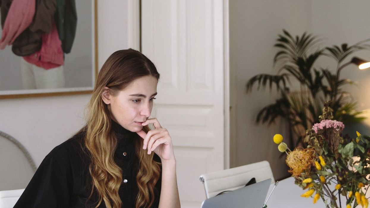 Person looks at laptop