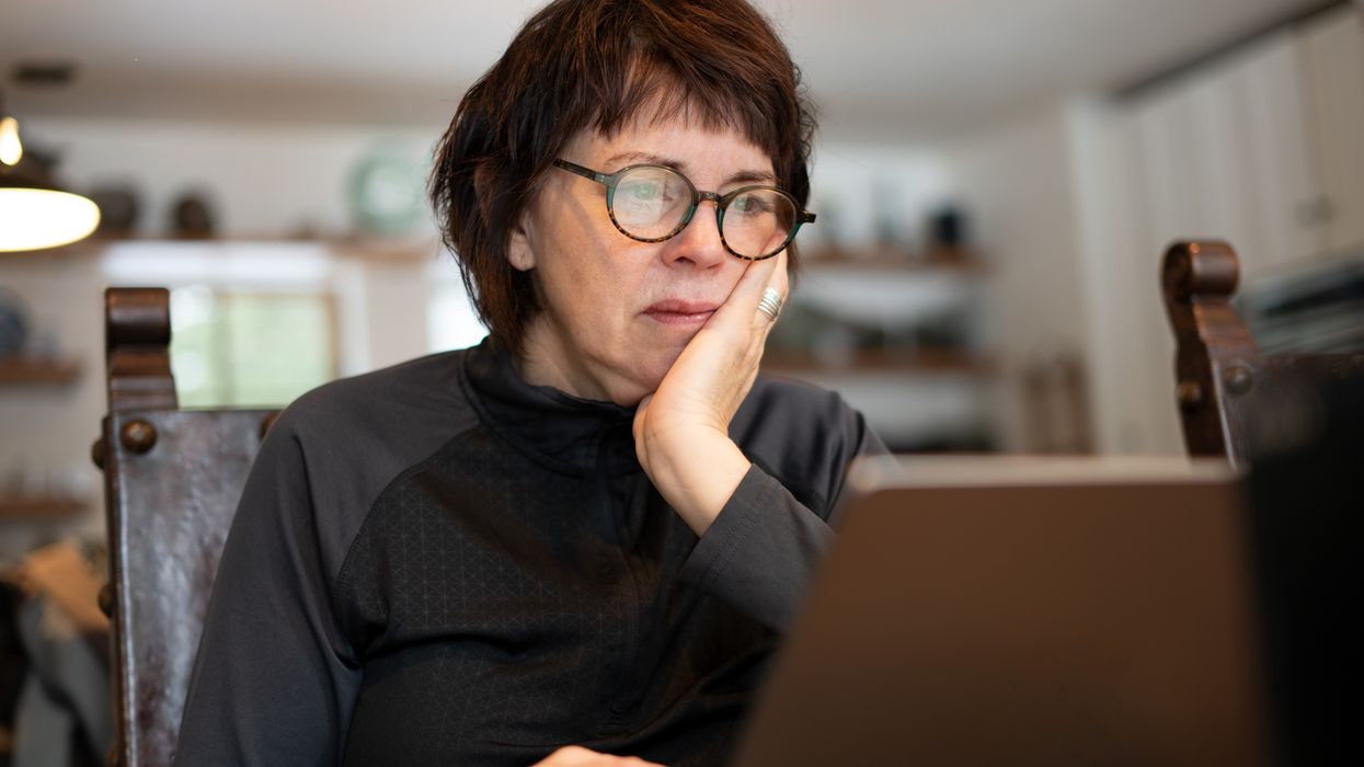 Person looks at laptop