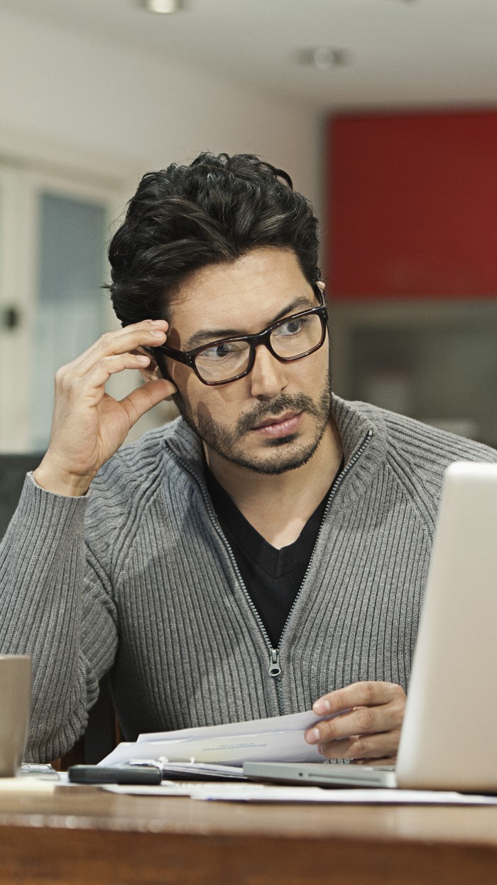 Person looks at laptop