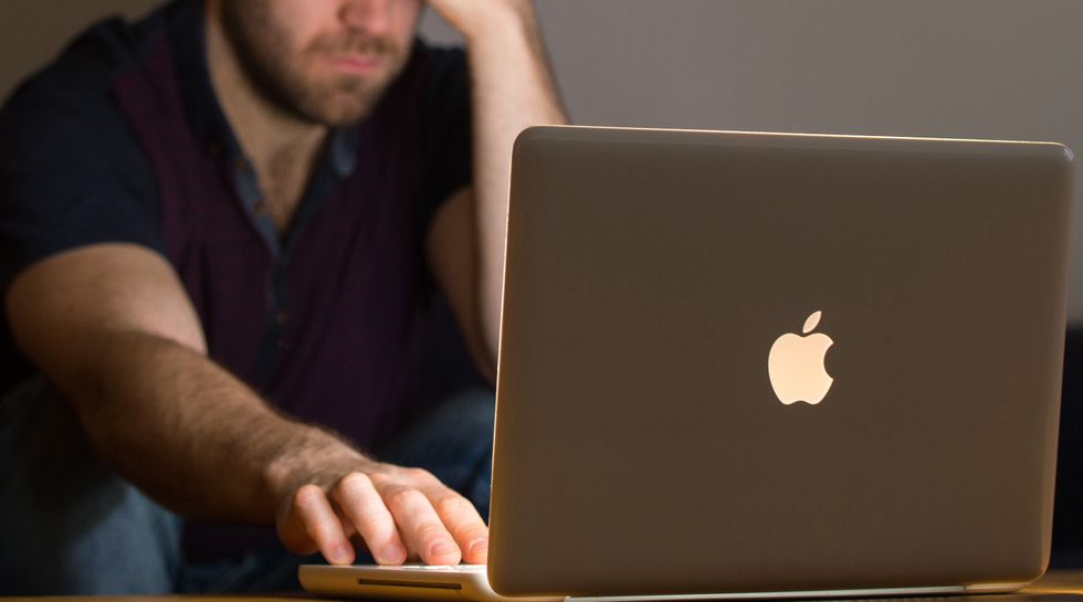 Person looks at laptop