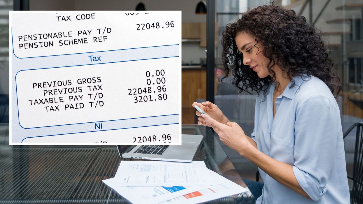 Person looks at mobile and documents beside image of payslip