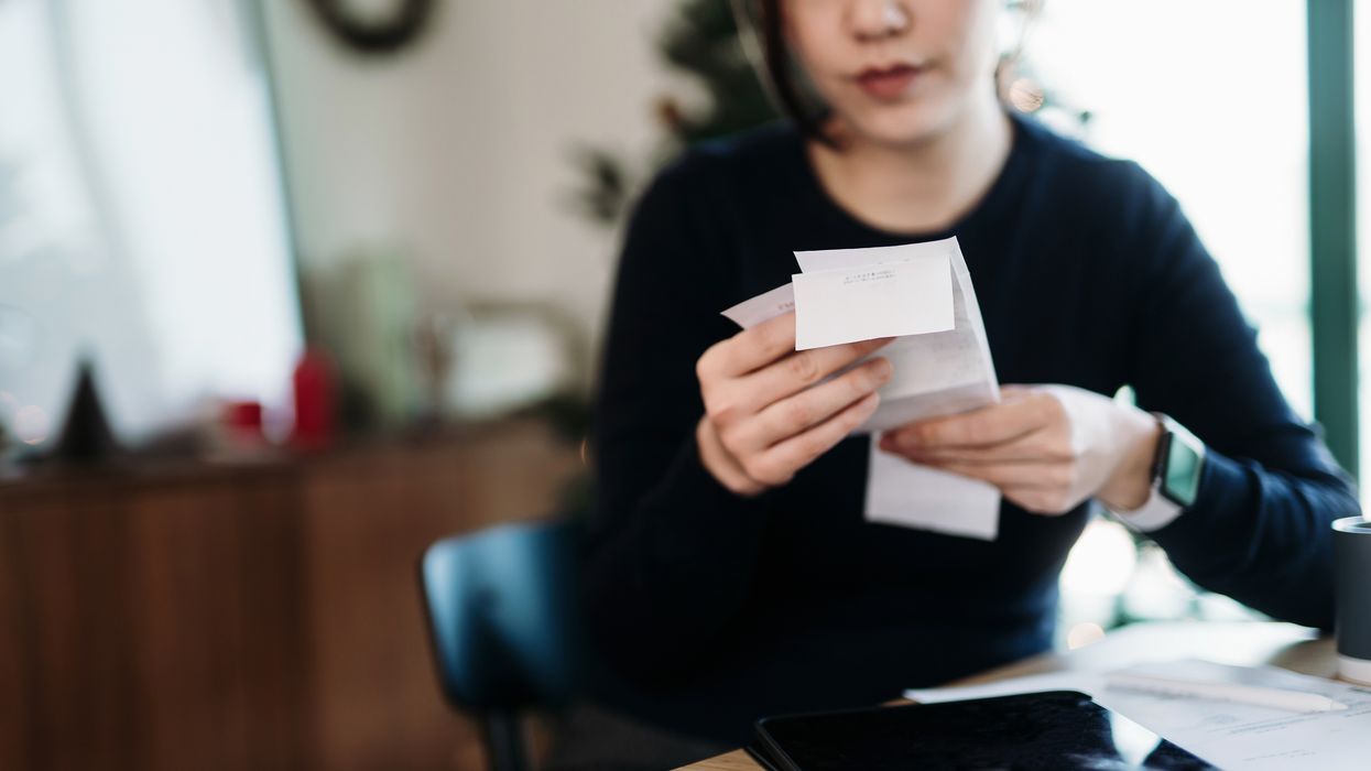 Person looks at receipts