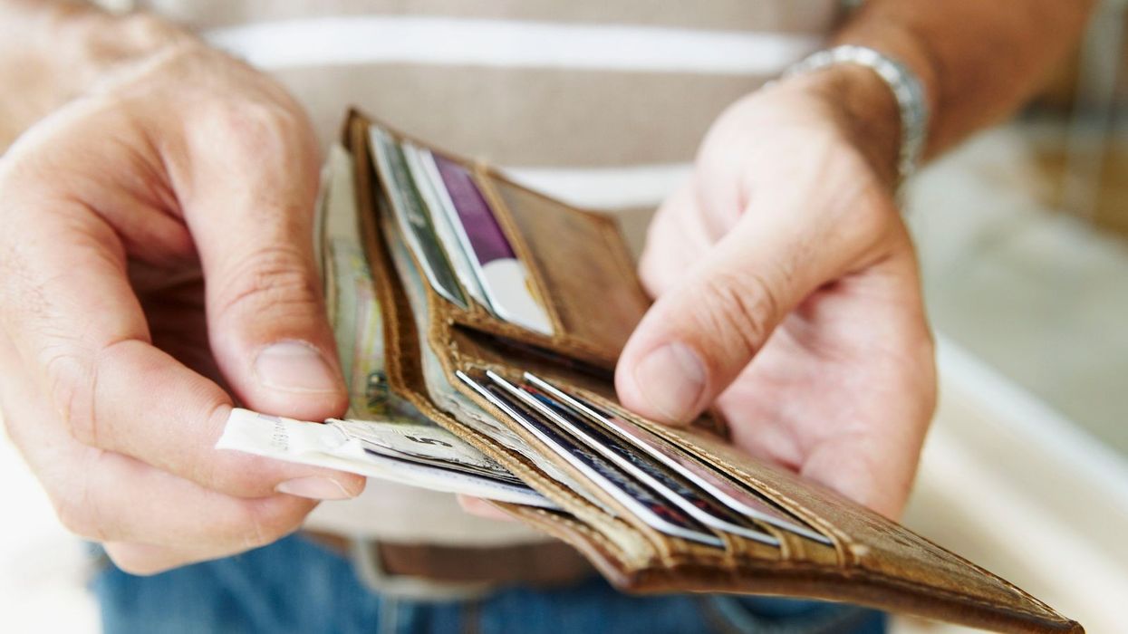 Person looks at wallet