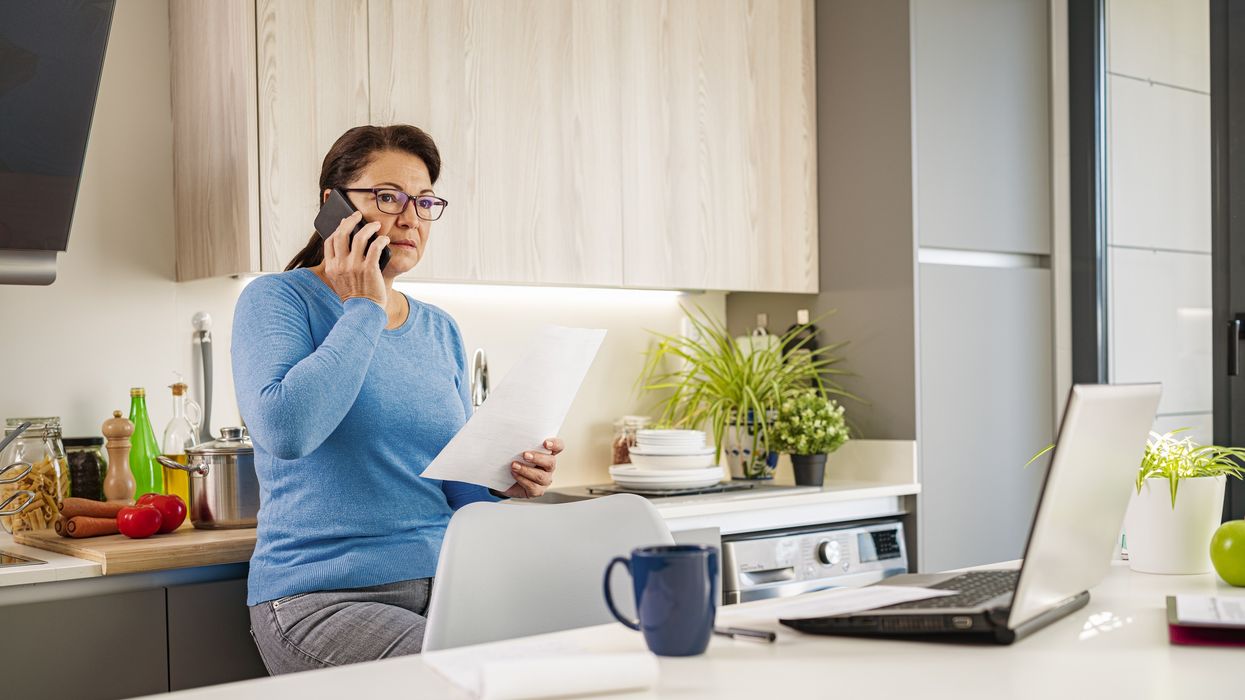 Person looks confused on phone with letter in hand