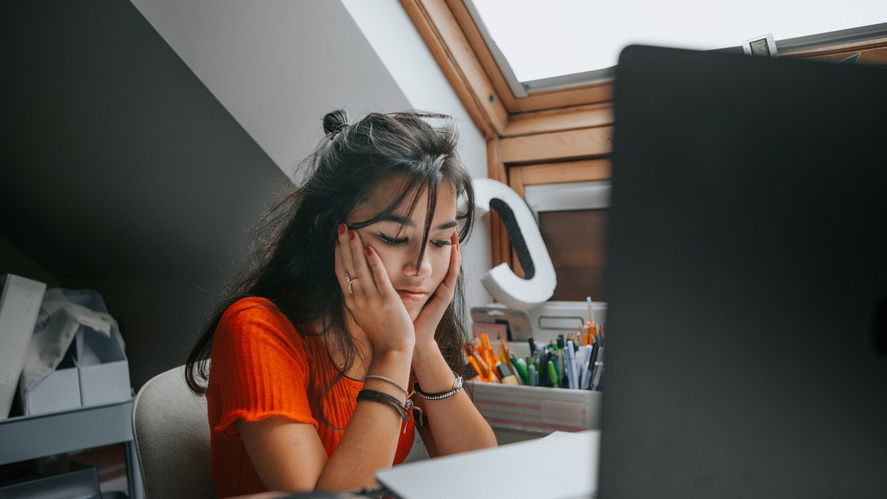 Person looks sad at laptop