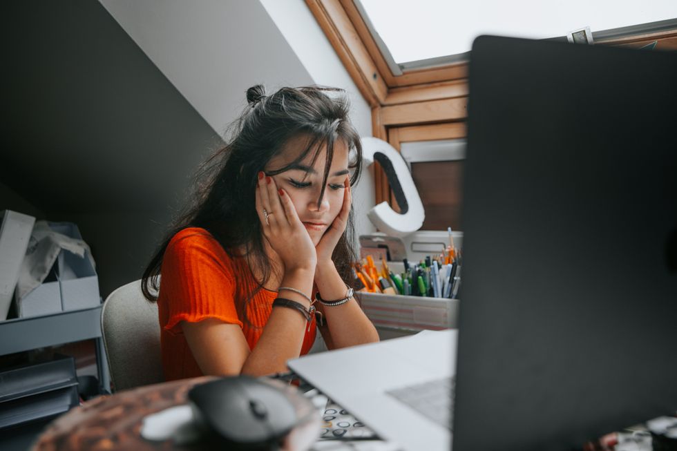 Person looks sad at laptop