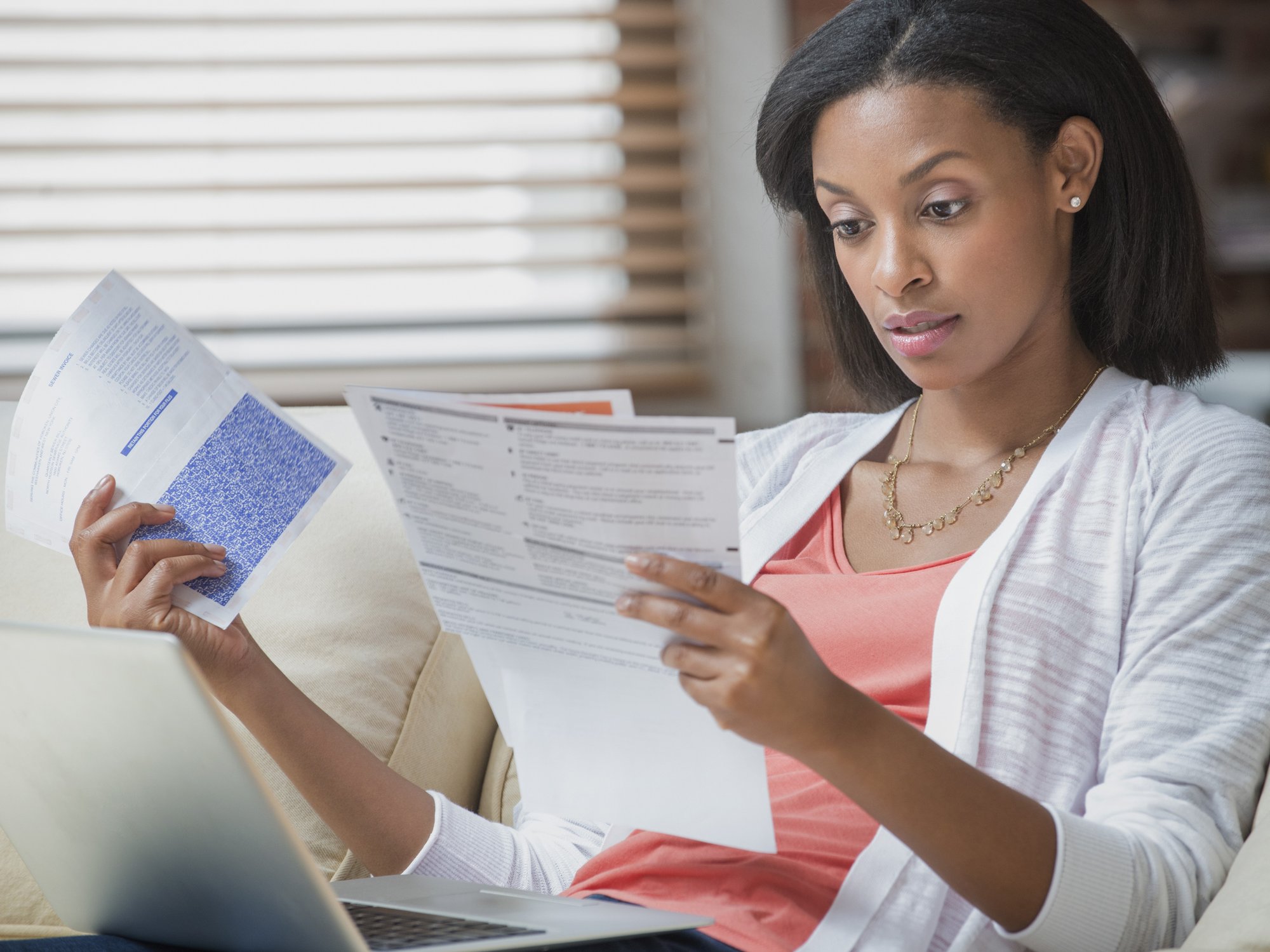 Person looks worried at water bill statement