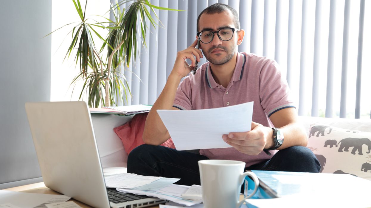 Person looks worried at water bill statement
