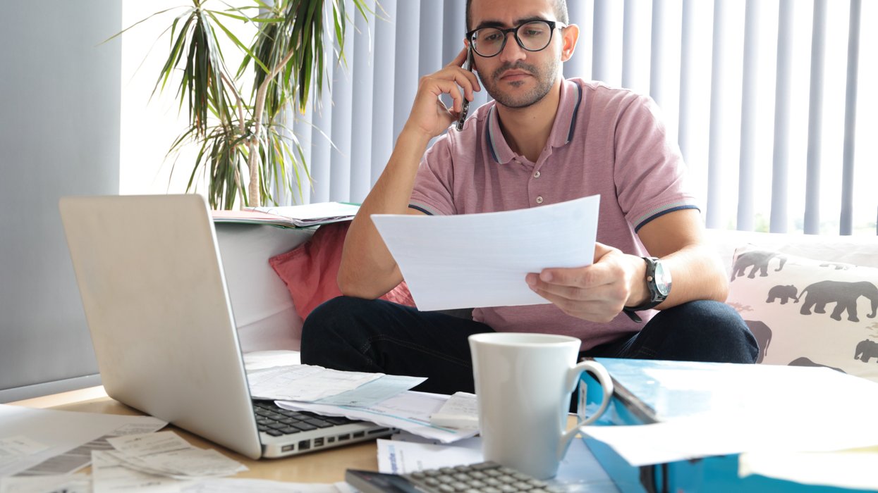 Person looks worried at water bill statement