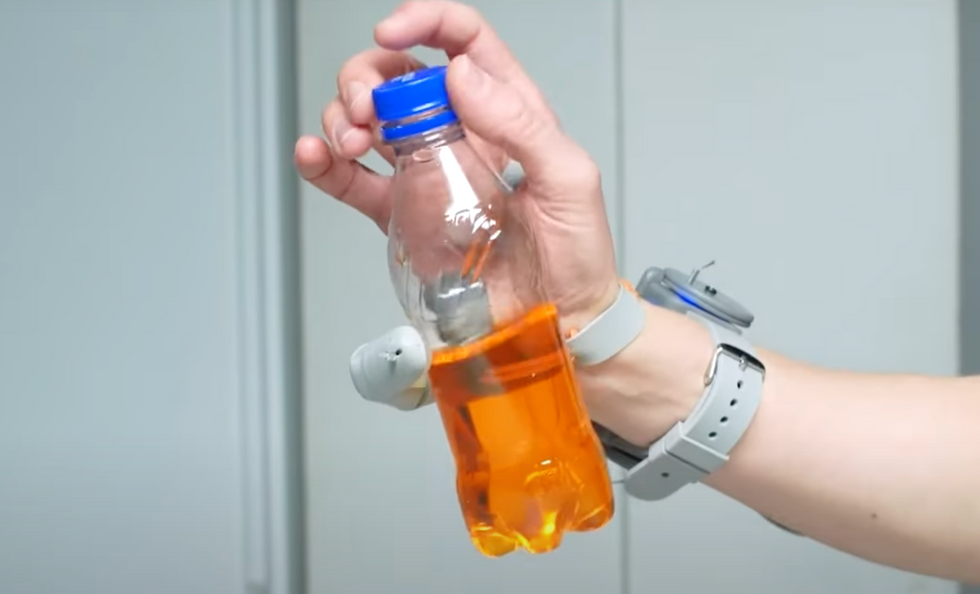 Person opening a bottle with one hand