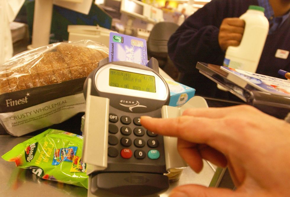Person paying for shopping with a debit card
