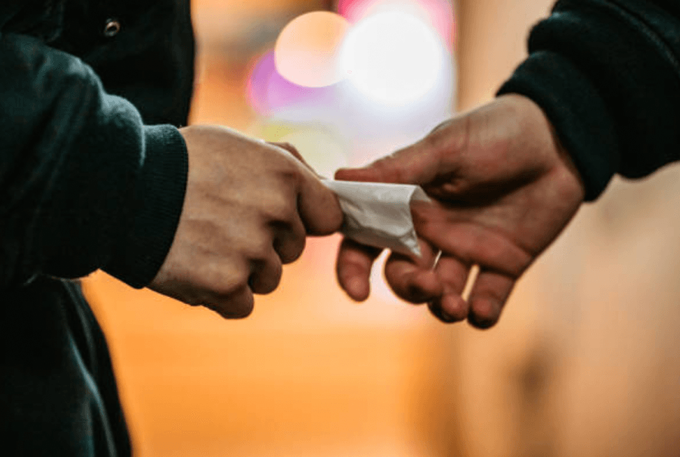 Person picking up drugs