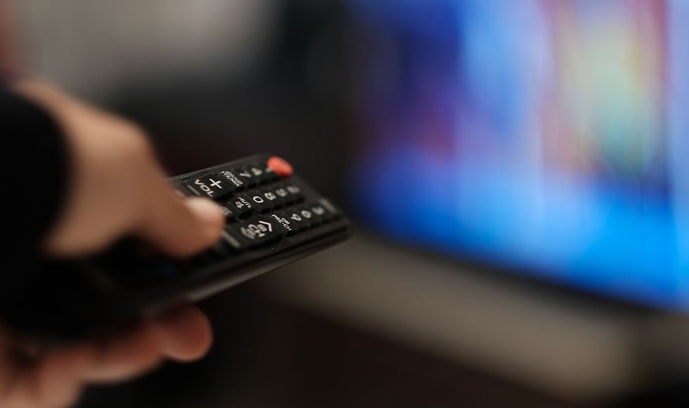 Person pointing their remote at the TV