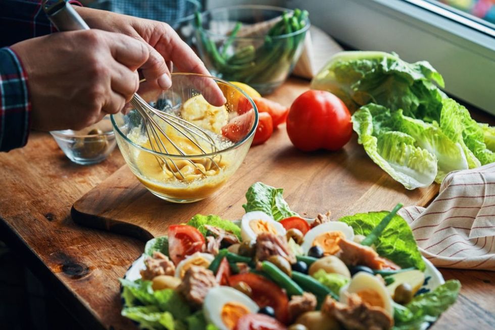 PERSON PREPARING SALAD