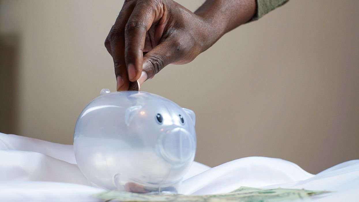 Person saving money in money box