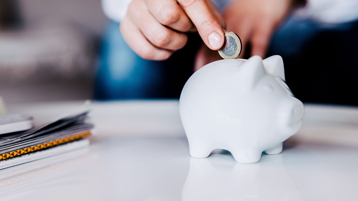 Person saving money in piggy bank