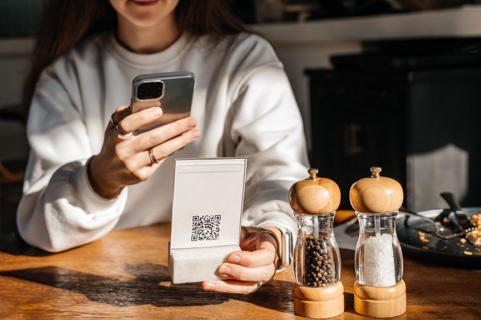 Person scans QR code on phone