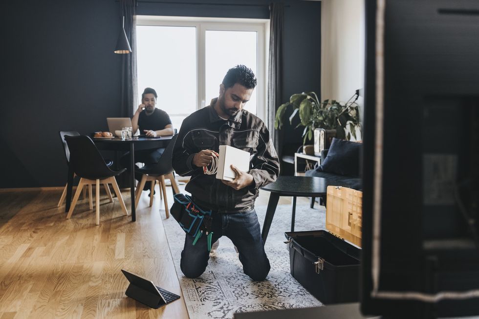 Person setting up wi-fi router in the home