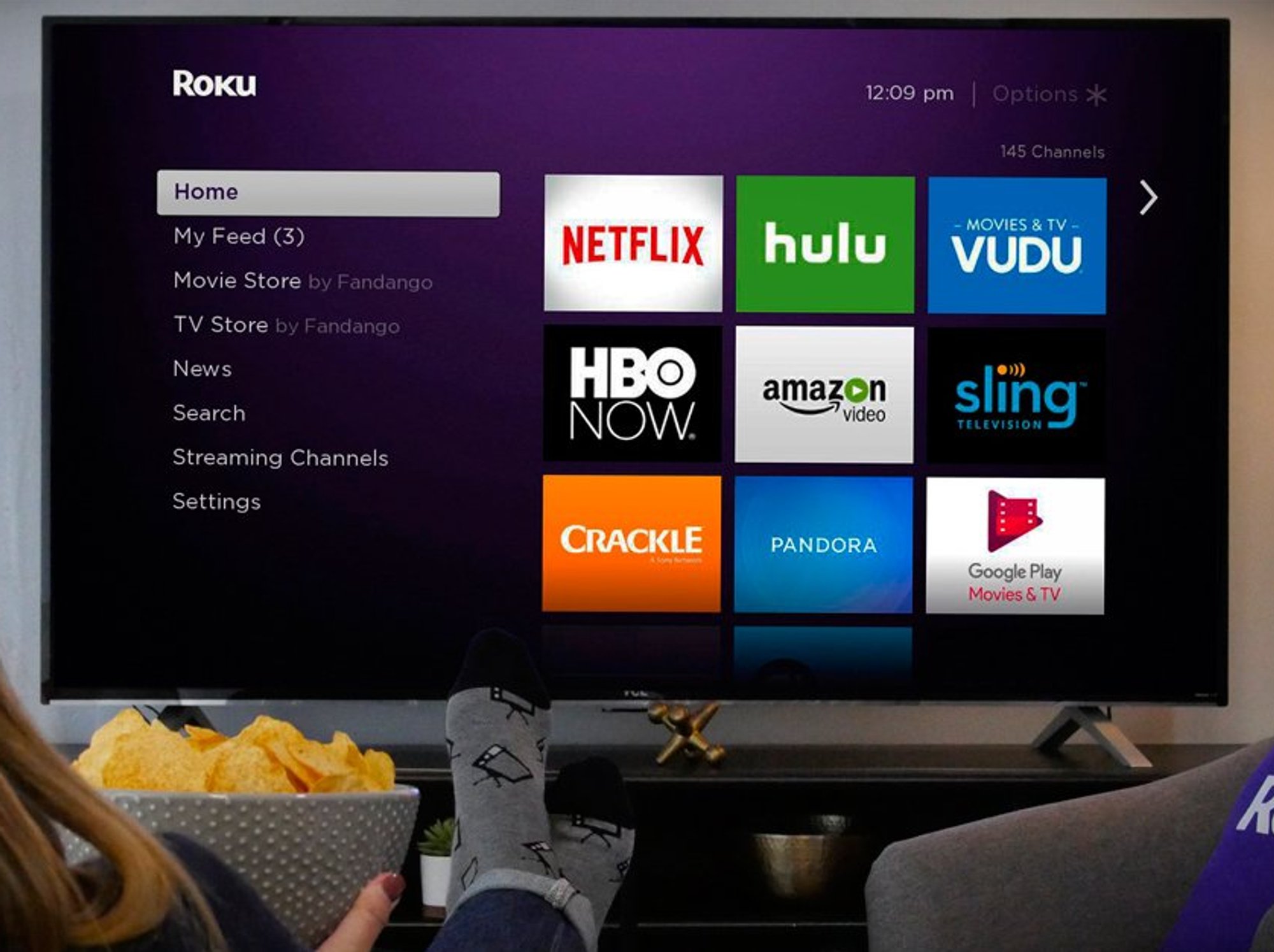 Person sitting in front of Roku TV