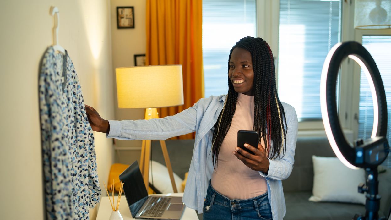 Person takes photo of second-hand clothes for online sale