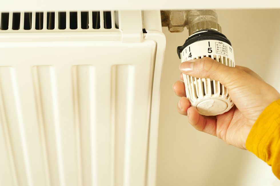 Person turning on radiator