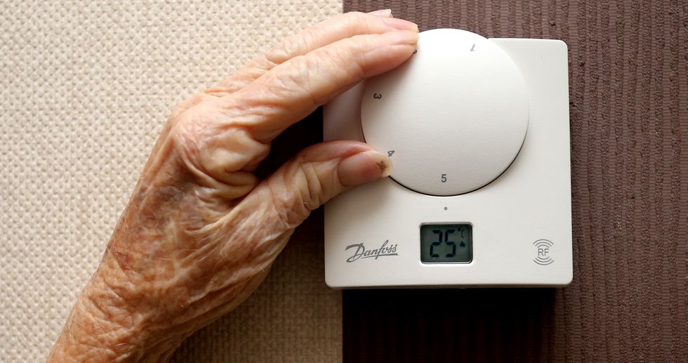 Person turns up thermostat for higher central heating