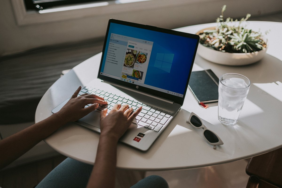 Person typing on laptop powered by Windows 11