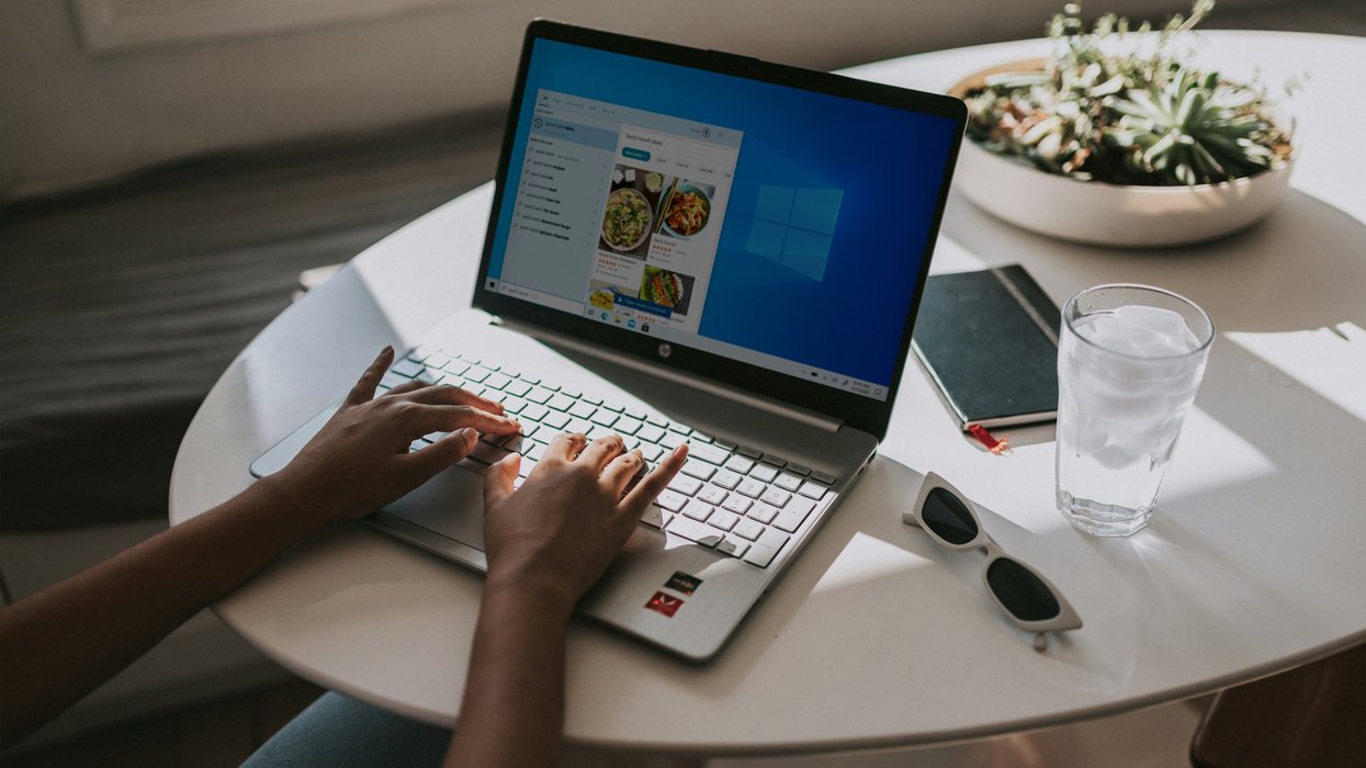 Person typing on laptop powered by Windows 11