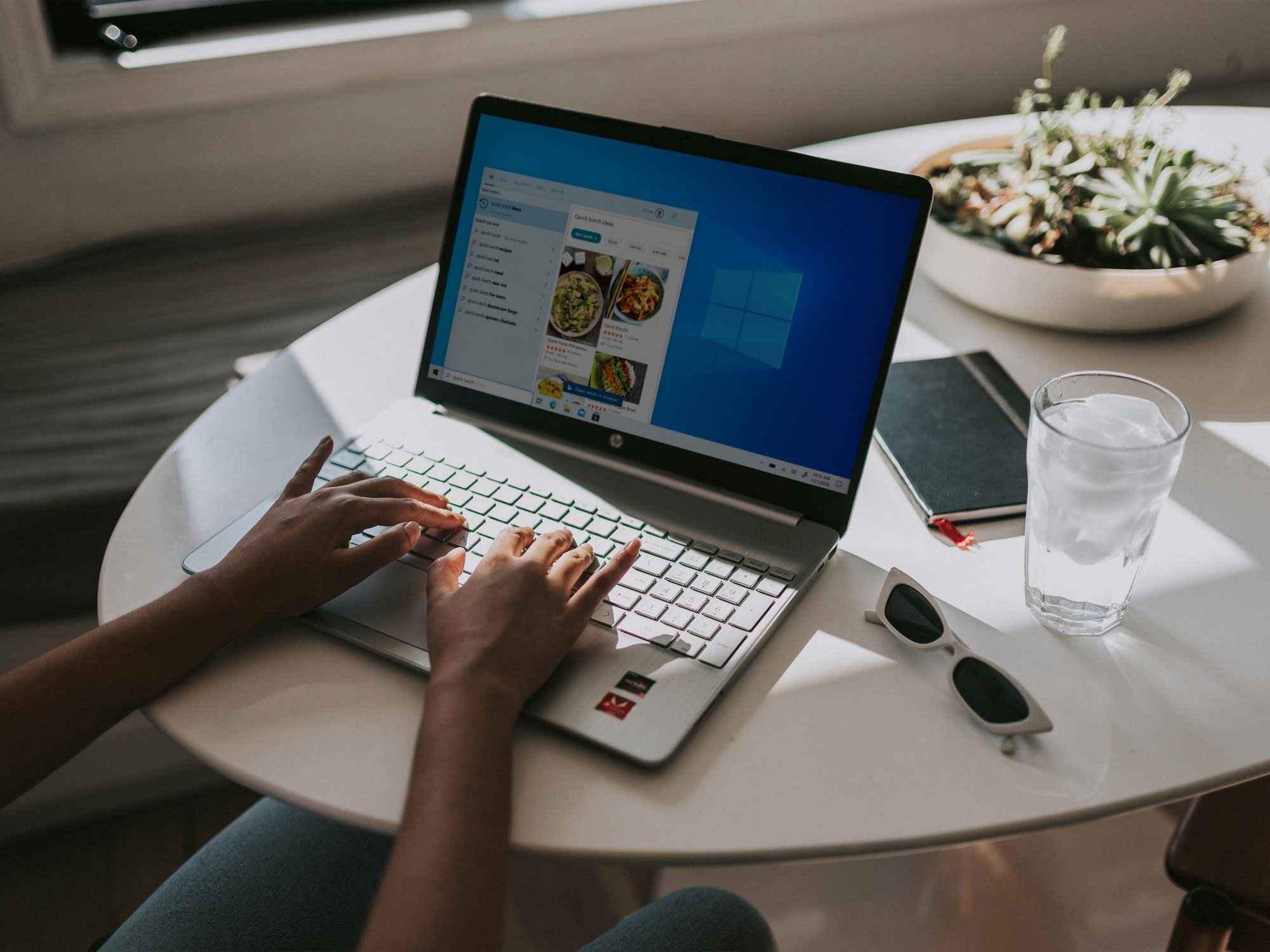 Person typing on laptop powered by Windows 11