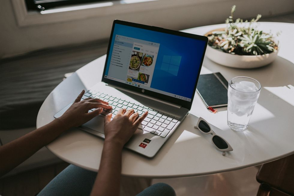 Person typing on laptop powered by Windows 11