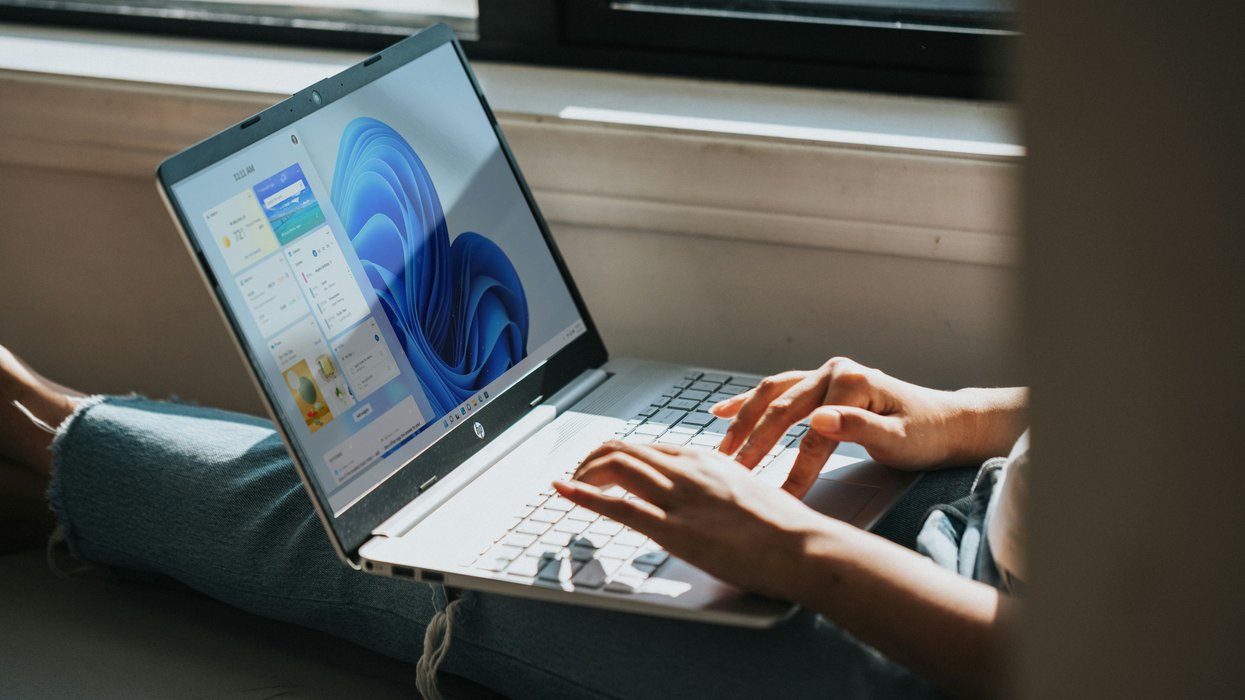 Person typing on Windows 11 laptop