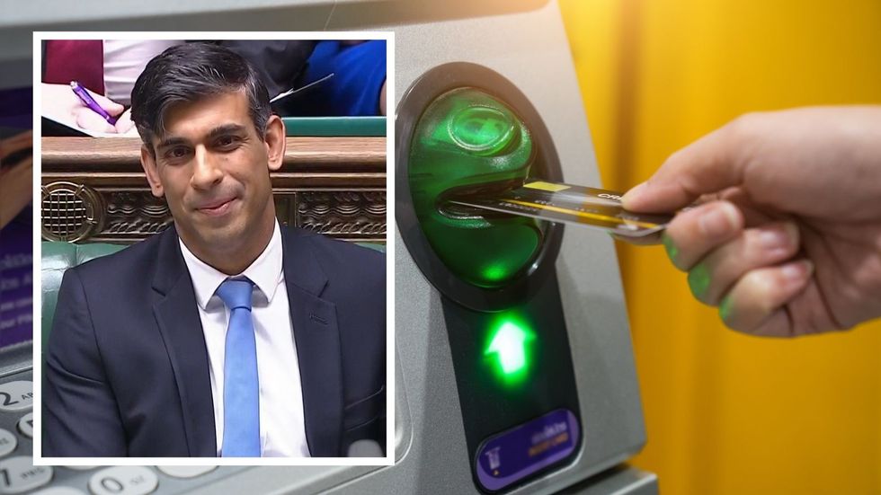 Person uses ATM to withdraw cash