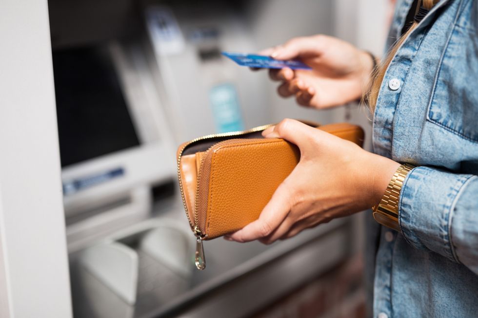 Person using ATM with bank card