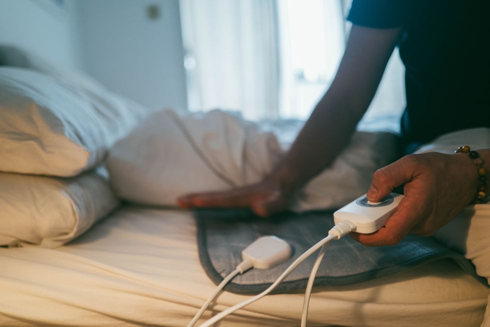 Person using electric blanket