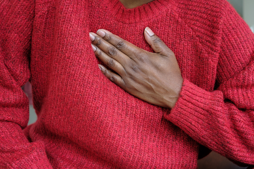 Person with hand to chest