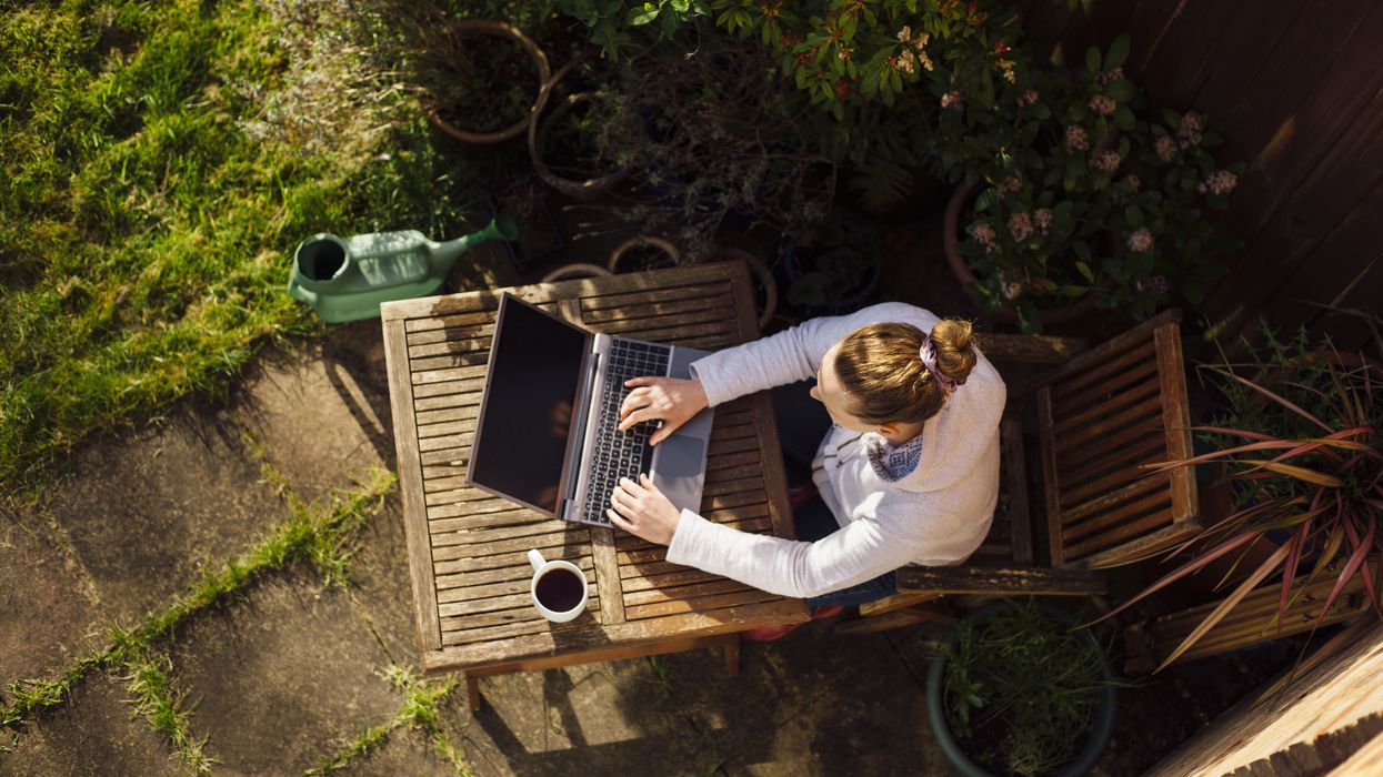 Person works from home in garden on sunny day