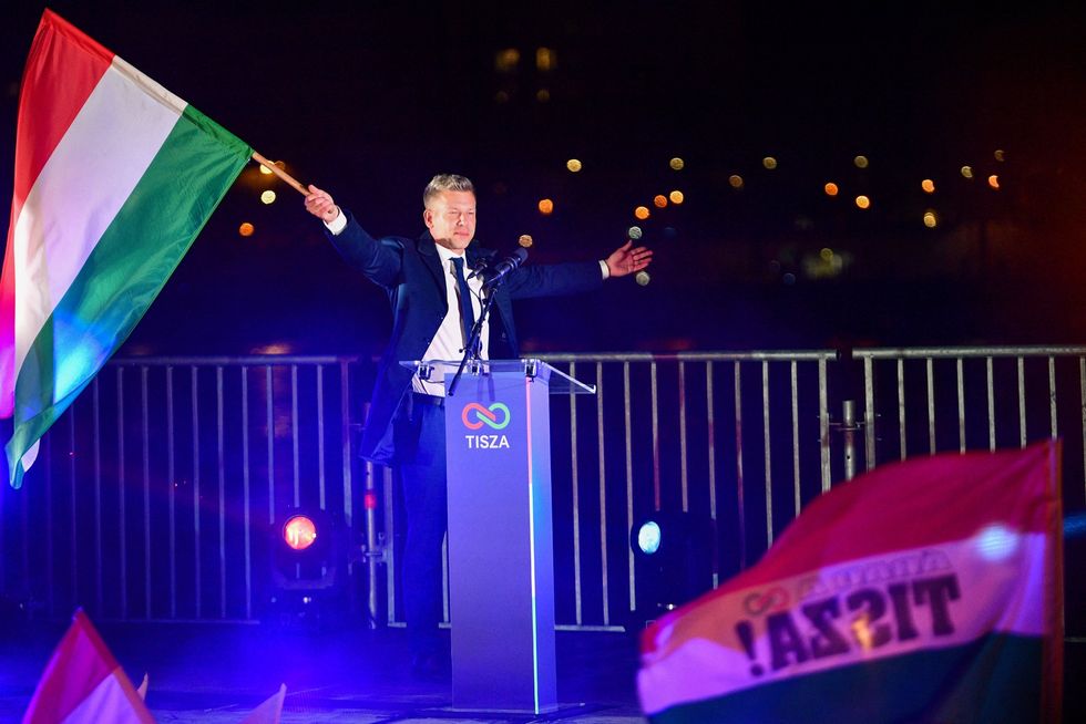 Peter Magyar waving Hungarian flag after his party's victory on Friday