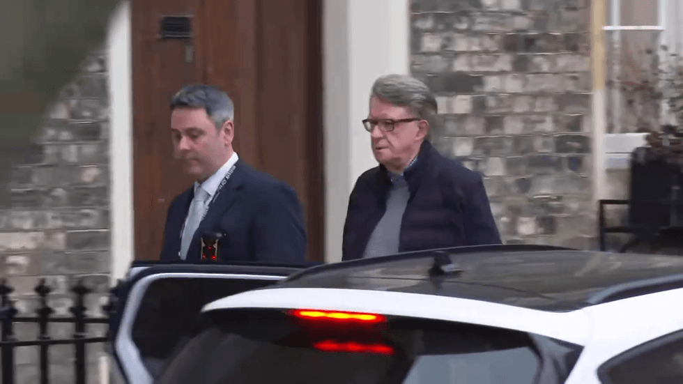 Peter Mandelson being led from his home by police