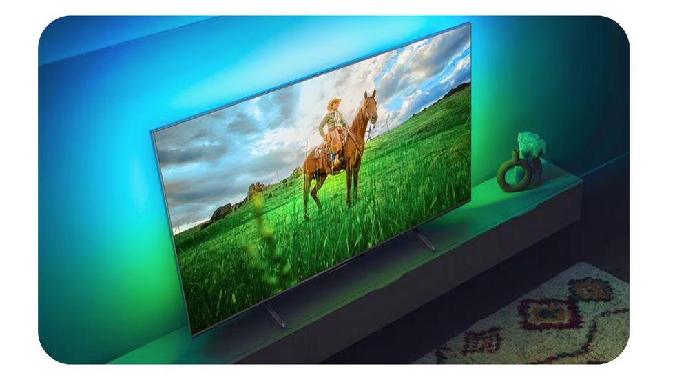 philips ambilight television on a media unit showing the led lights illuminating the background