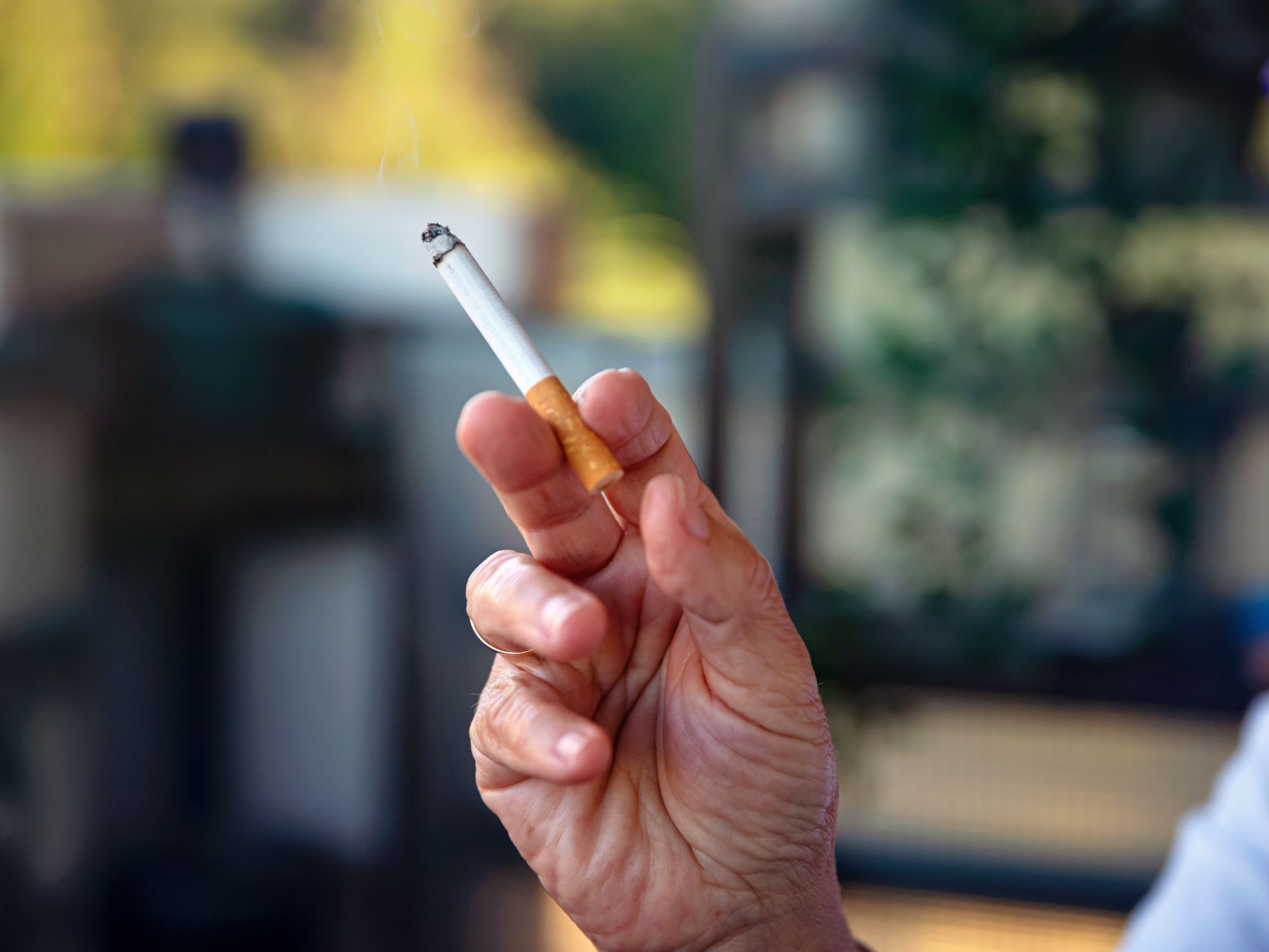 Picture of an older person holding a cigarette