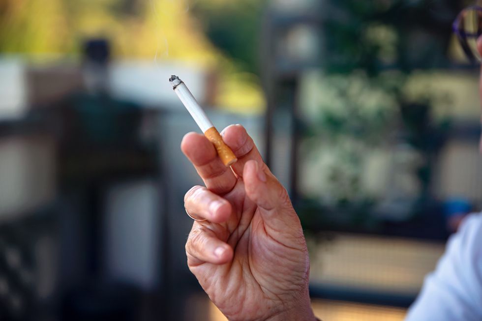 Picture of an older person holding a cigarette
