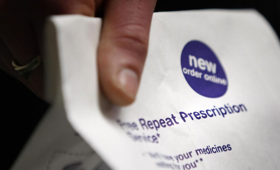 PICTURE POSED BY MODEL. A man holds a prescription bag after prescription charges were abolished in Scotland today.