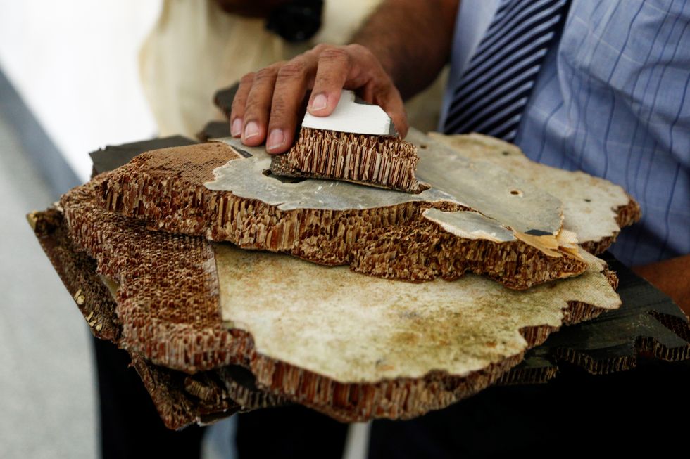 Pieces of debris found in Madagascar, believed to be from flight MH370 were shown to media members before handing over to Malaysia's Transport Minister Anthony Loke in Putrajaya on November 30, 2018.