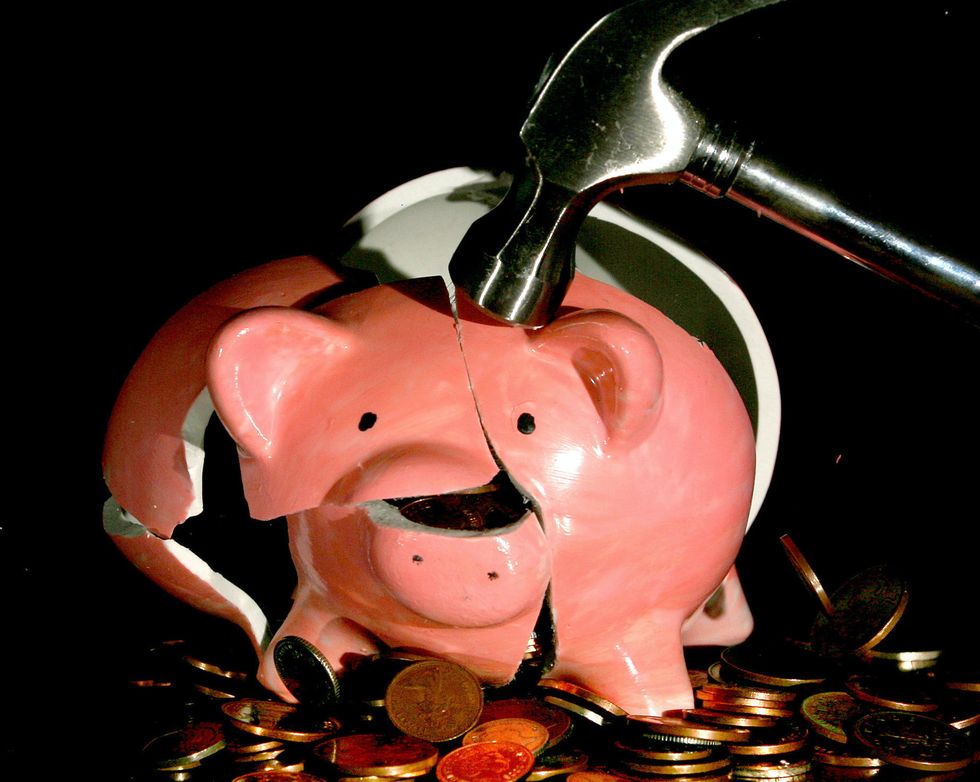 Piggy bank is smashed open with a hammer