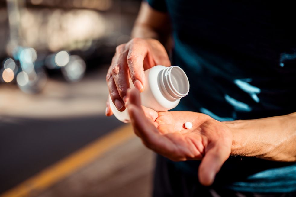PILLS IN MAN'S HAND